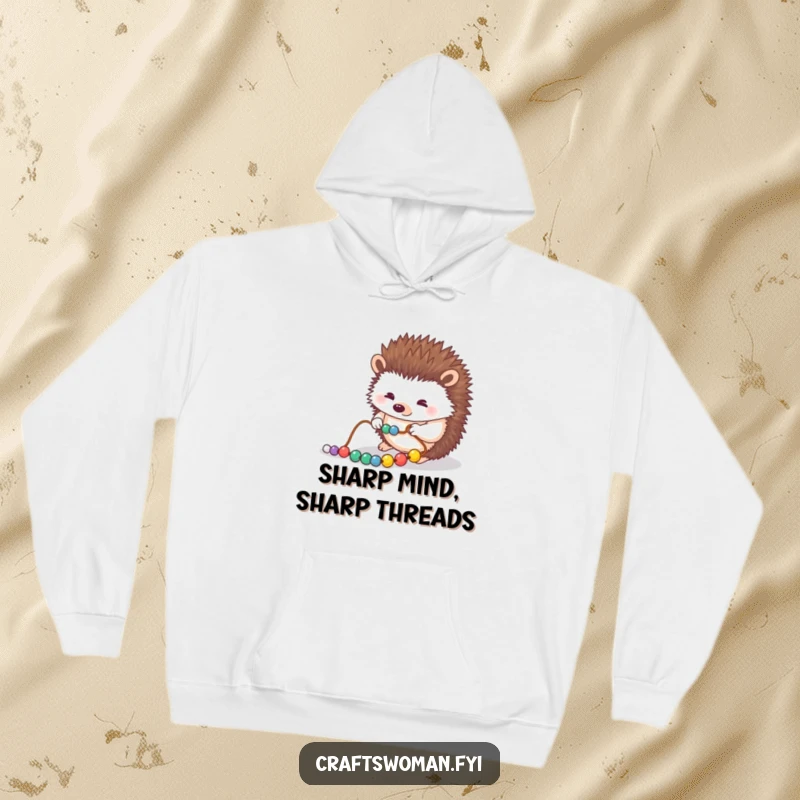 Funny hoodie showing a diligent hedgehog carefully stringing beads, embodying patience and a love for detailed craftwork.