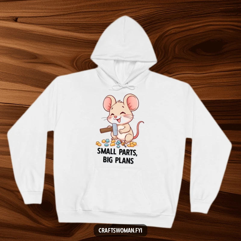 Funny mouse hoodie showing a delighted mouse character using a miniature hammer to assemble small pieces, perfect for cozy building.