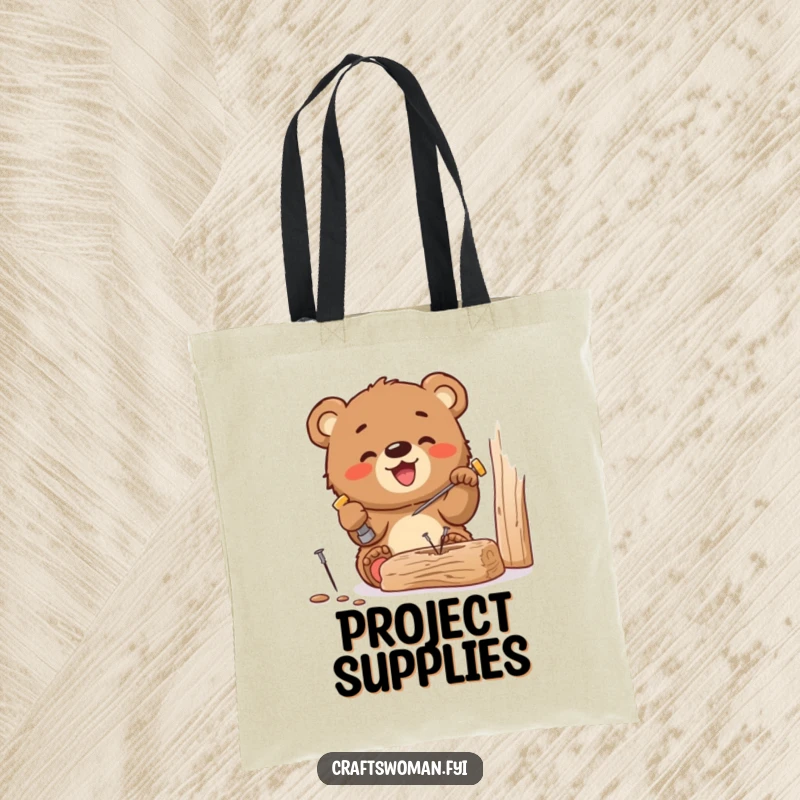 Funny tote bag featuring a gleeful bear cub hammering a tiny nail into wood, perfect for carrying tools and DIY supplies with charm.